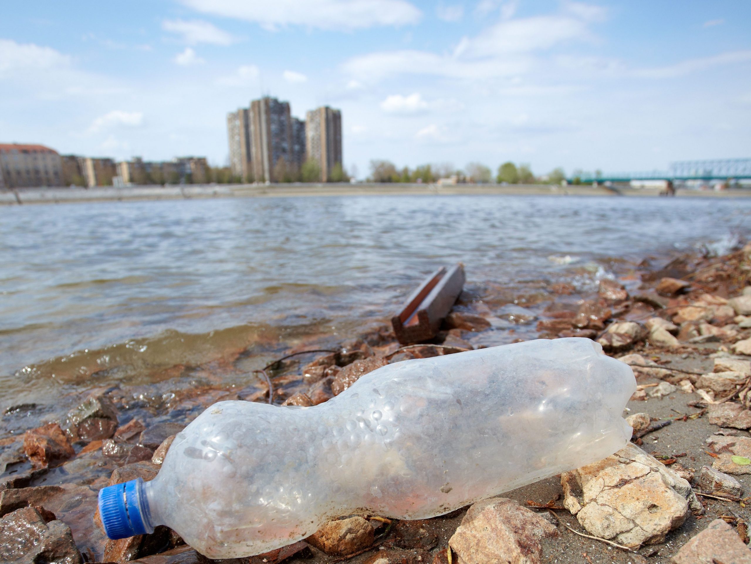 Image showing a plastic bottle next to one of Britain's waterways