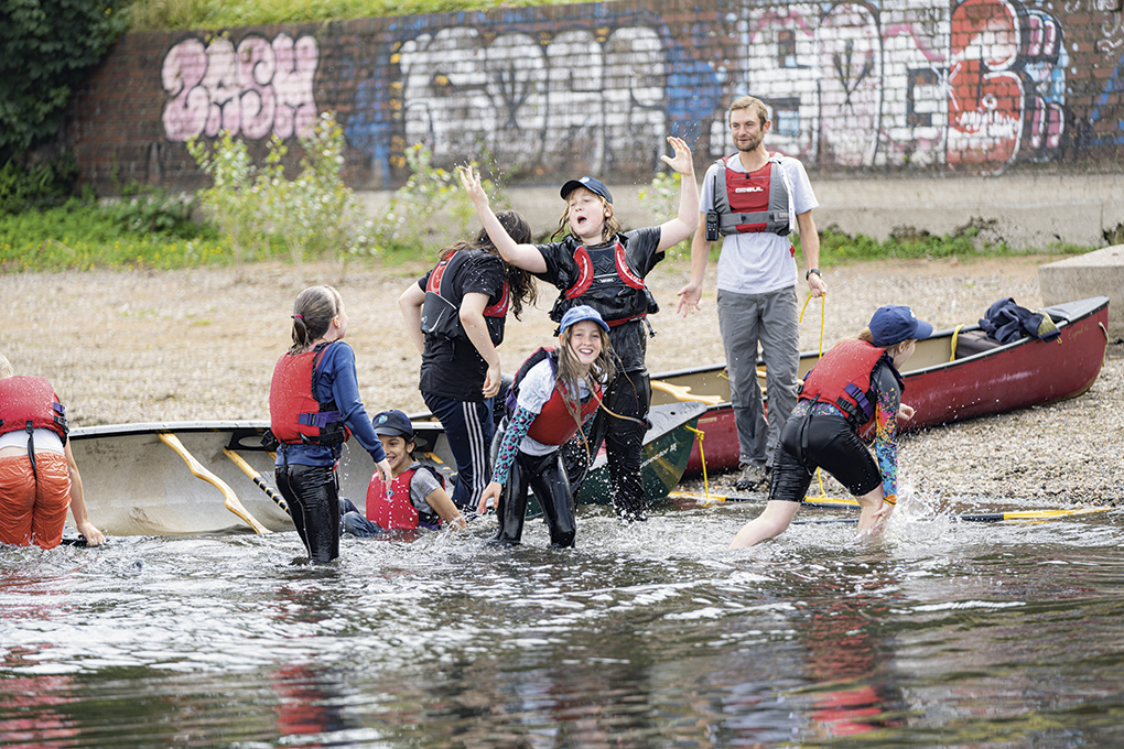 Photo of a group of young people launching a boat
