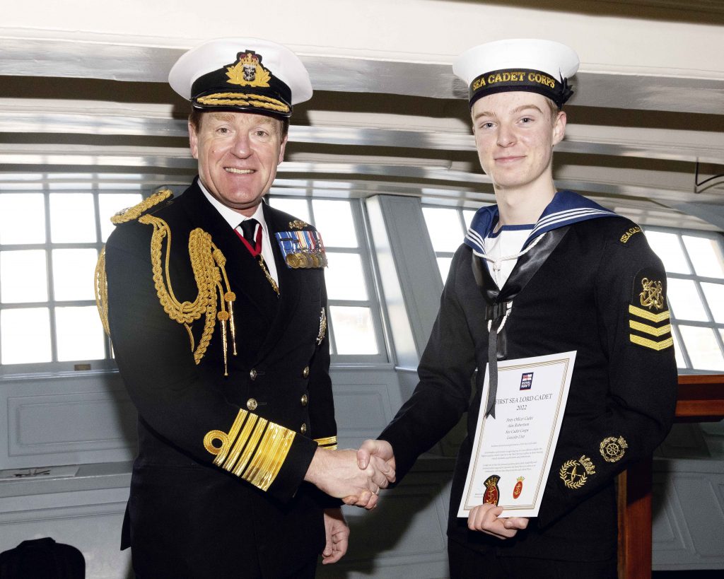 Alex accepts his certificate from the First Sea Lord