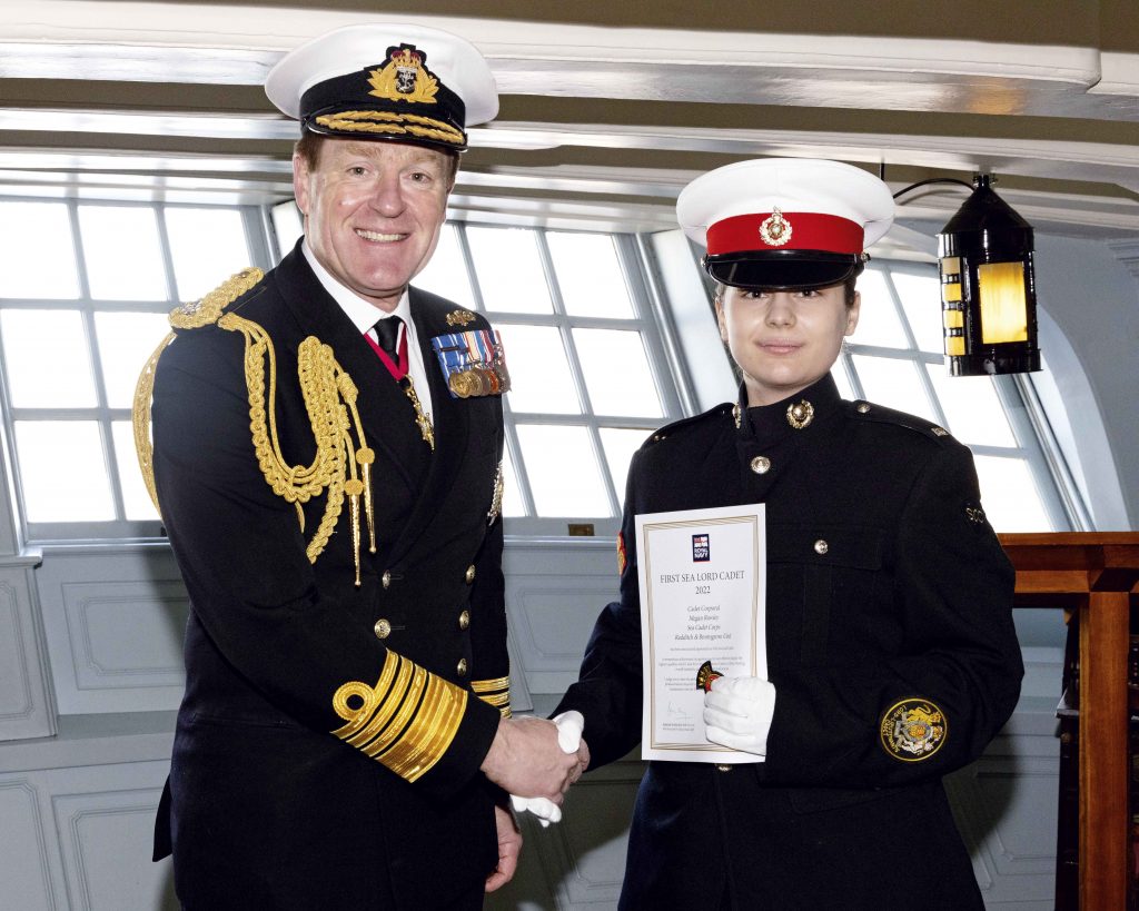 Megan accepts her certificate from the First Sea Lord