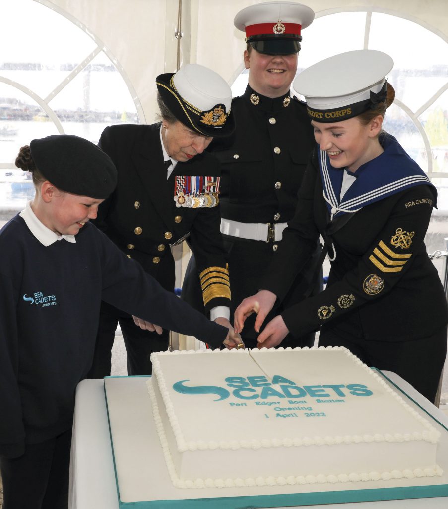 Princess Anne cuts the celebratory cake with the help of some cadets
