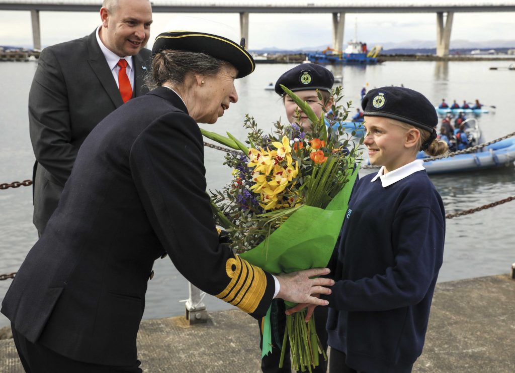 Princess Anne accepts flowers from a cadet