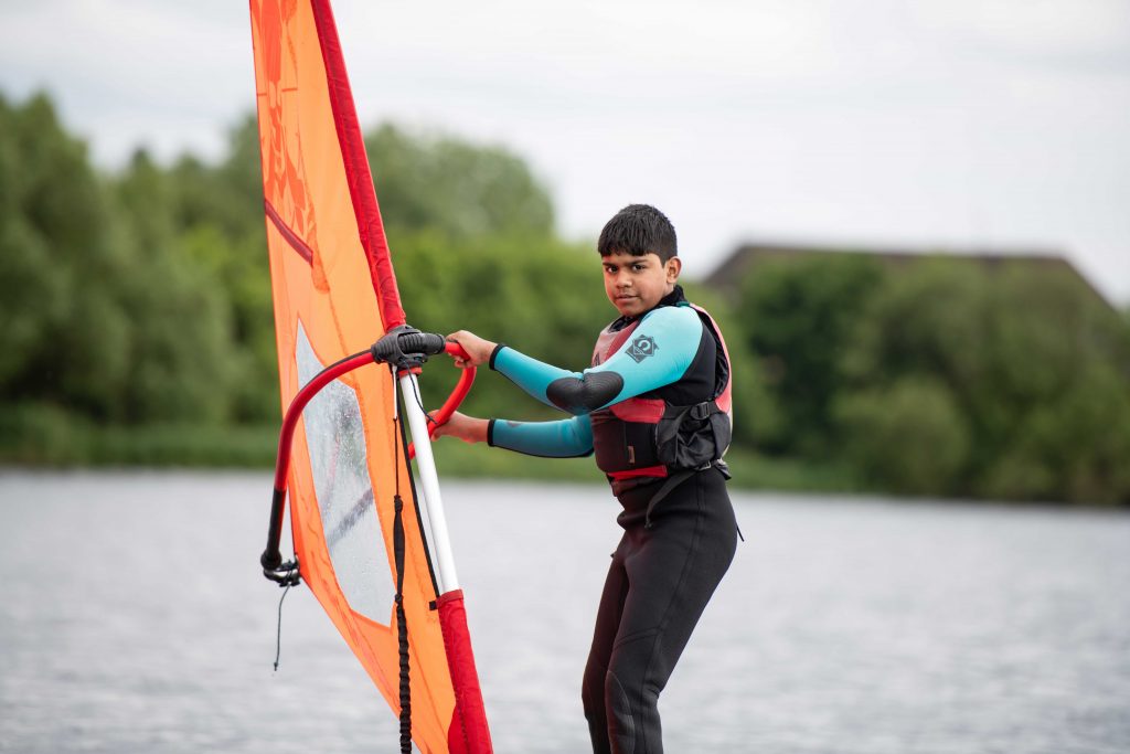 A young boy windsurfing