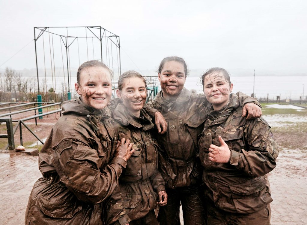 a group of female RMCs with mud on their faces after taking part in the gib cup