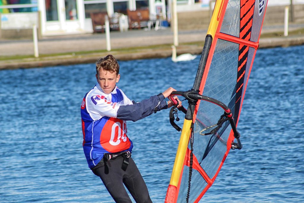 a male cadet windsurfing