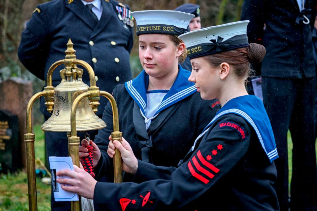 cadets help to ring the ceremonial bell