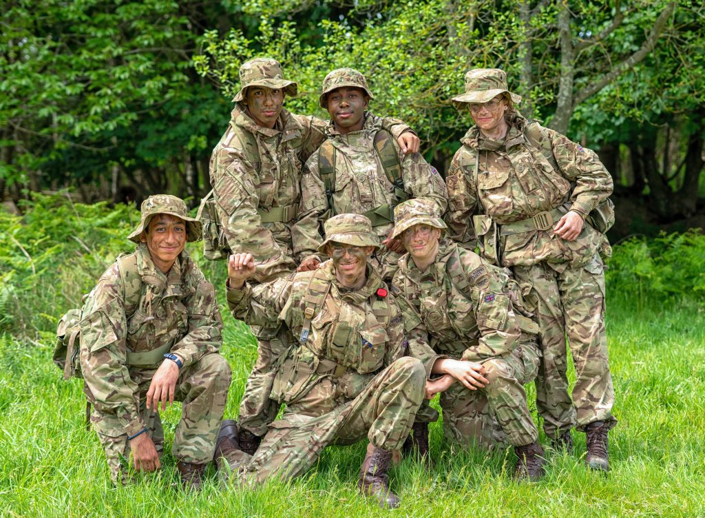 a group of RMCs at a training weekend pose and smile for the camera