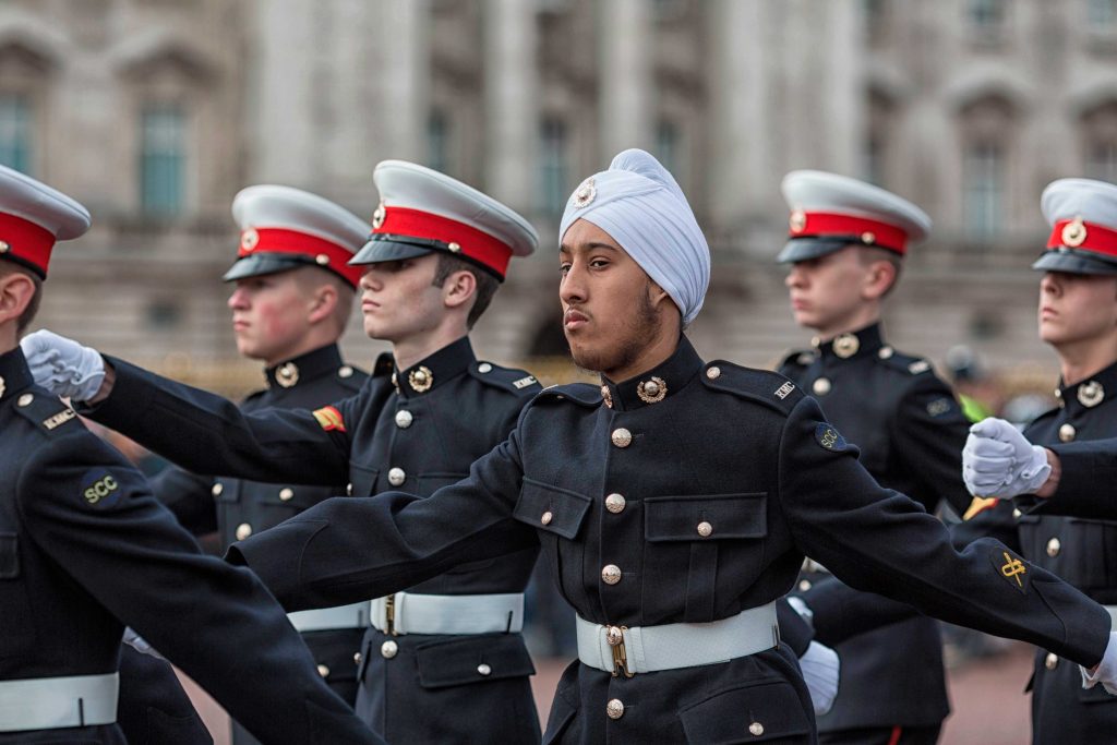 Cadets march at Trafalgar Day, one is wearing a turban