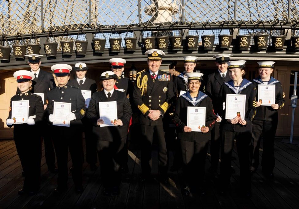 The First Sea Lord's Cadets for 2022 pose with the First Sea Lord holding their certificates