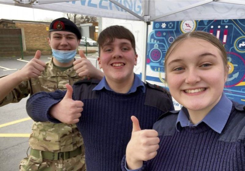 Cadets smile and give a thumbs up to the camera