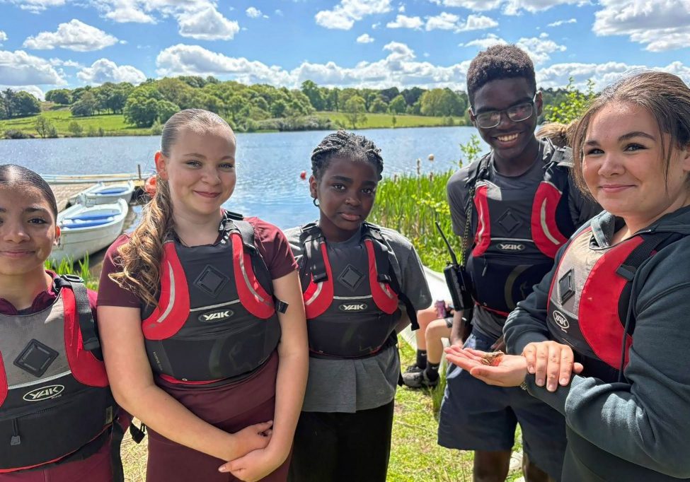 Liverpool West Derby Unit members relax after a boating session in beautiful surroundings.