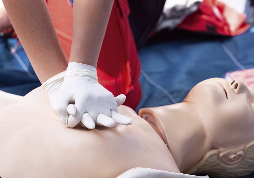 Photo of a sea cadet practising CPR on a dummy during a First Aid course