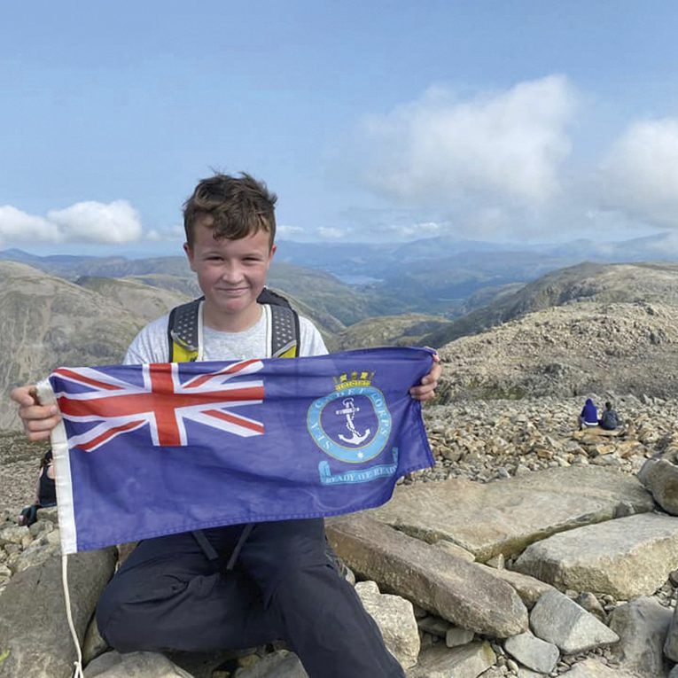 A photo of Cadet Craig at the summit of Scafell Pike