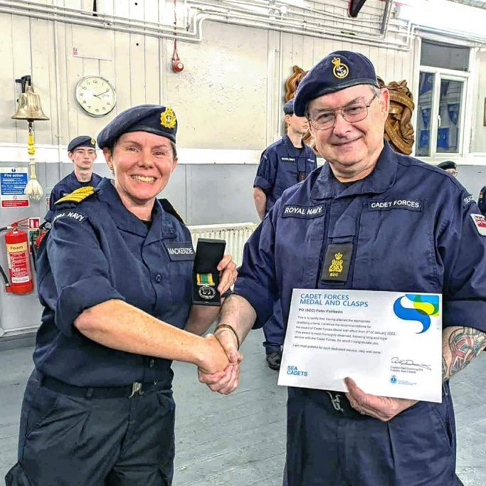 Captain Hannah presenting PO Fairbairn with a Cadet Forces Medal