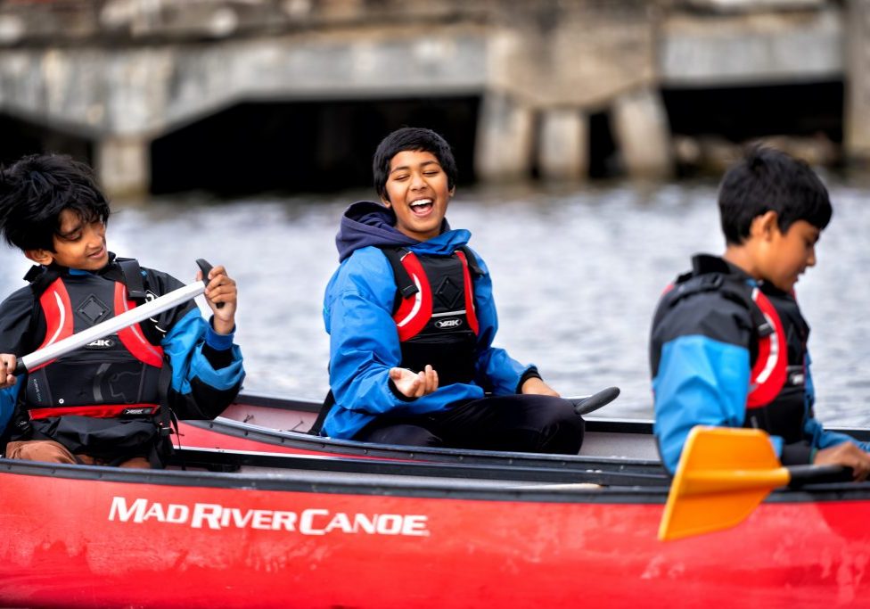 Young people smile and laugh as they take part in On The Water