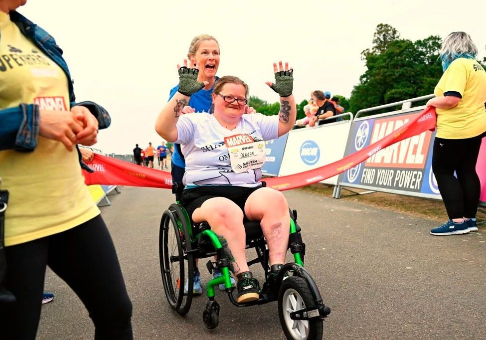 Orange triumphant at the Superhero Triathlon finish line