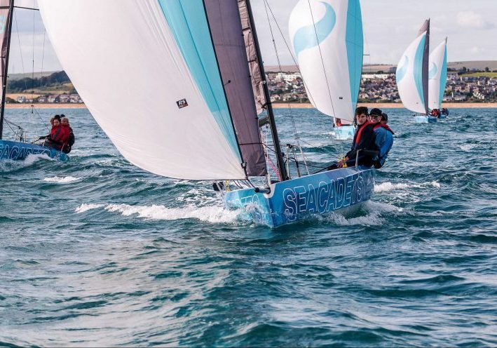 Cadets sailing dinghies with full sails